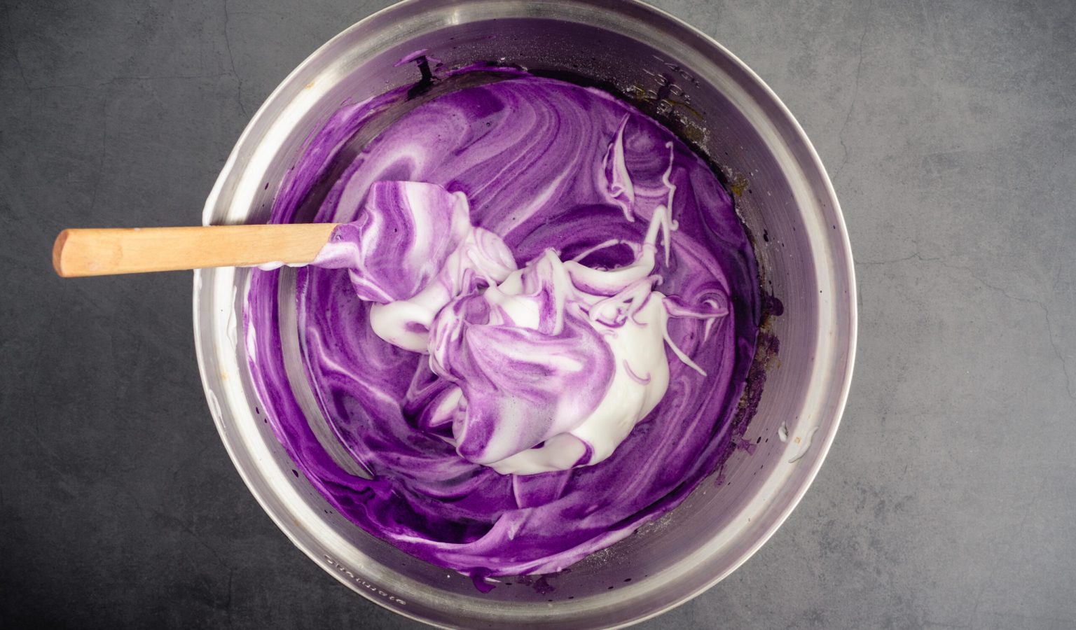 Mixing Meringue into Ube Cake Batter: Using a spatula to mix up cake batter made with purple sweet potatoes